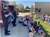 Firefighter talking to group of kids