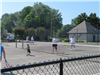 People playing tennis on the courts