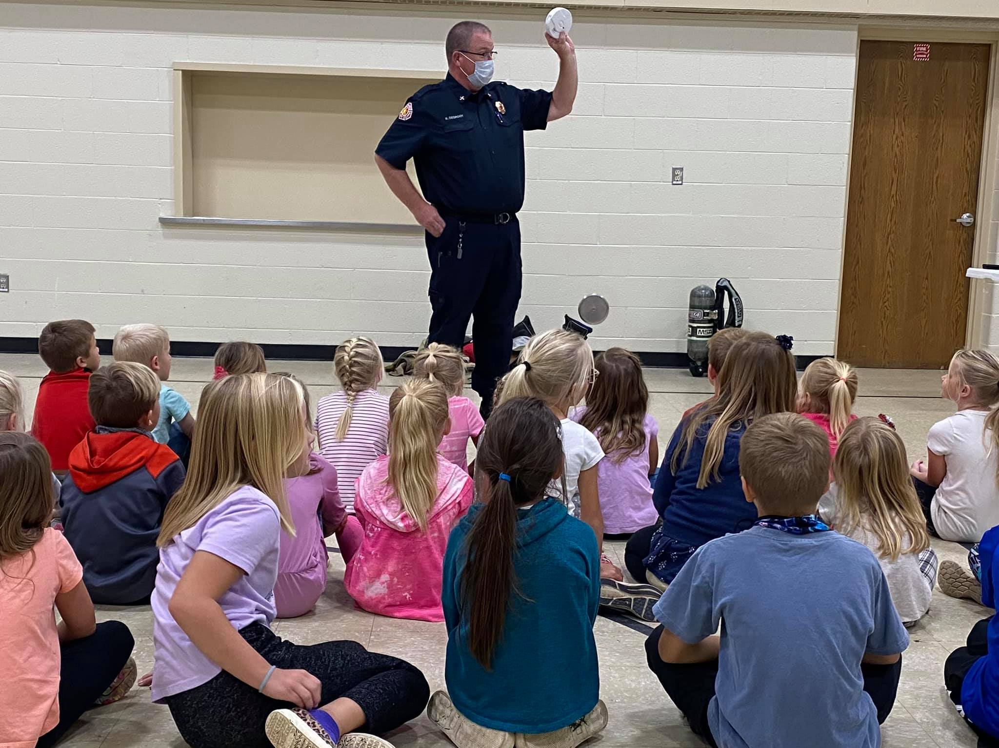 FIre Marshal holding smoke alarm