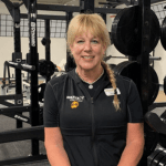woman standing in front of fitness equipment